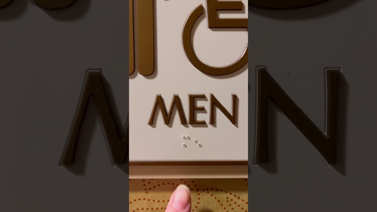 Decoding the men’s restroom sign in braille. 