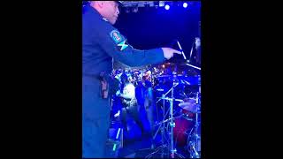 Cops trying to arrest the Drummer.