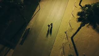 Aerial View Of Two Friends Hugging And Dancing On Street In Dark Under Street Lights - 1204732-3