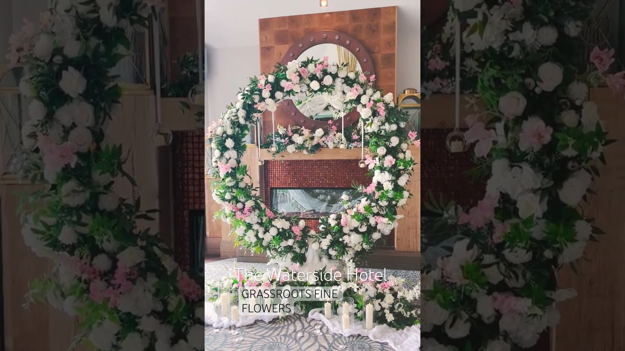 Pretty in Pink Ceremony Room Design with Arch, Chandelier, Hanging Globe Candles and Signing Table