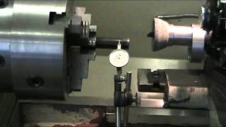 Checking the runout of the chuck jaws after grinding.
