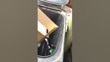 Putting pizza boxes in a bin.