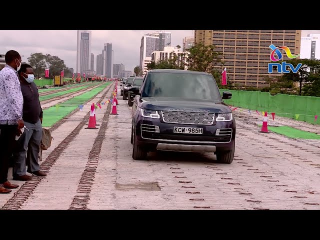 President Uhuru Kenyatta drives Range Rover on Nairobi Expressway class=