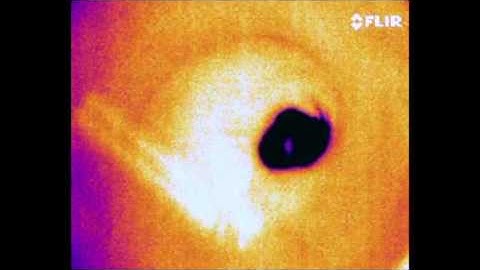 Ice disk melting at the surface of a hot bath (enhanced version)