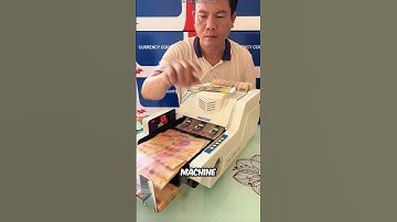 The guy demonstrates how a money counting machine works