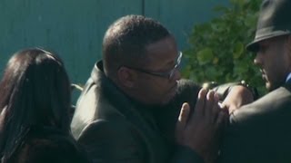 Whitney Houston Funeral - Bobby Brown comforts friend at funeral