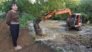 Excavators build stone embankments, dikes to protect stream banks - Building family farm life