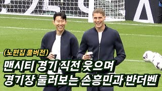 Son Heung-min and Micky van de Ven laughing on the pitch before the Man City game.