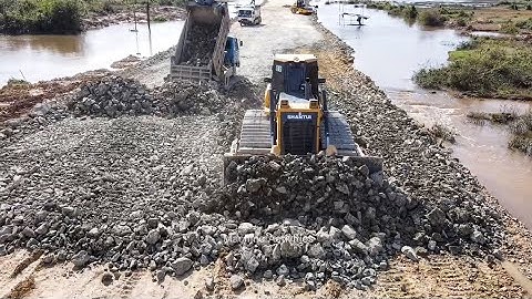 Next Level Construction Road From Province To City in Progress By Dozer SHANTUI Push Stone in Water