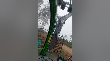 John Deere 810E unloading logs