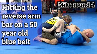 Hitting the reverse arm bar on a blue belt