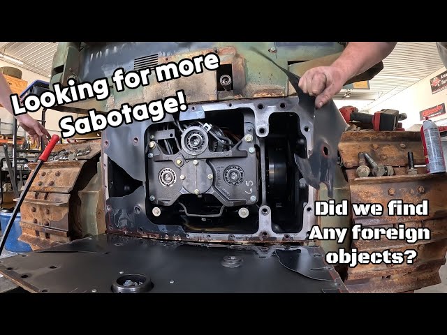 Looking for more foreign material inside the low hour broken military John Deere dozer class=