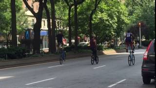 2 SHORT GUYS RIDING TALL BIKES & 1 TALL GUY RIDING A SHORT BIKE ON THE WEST SIDE OF MANHATTAN, NYC.