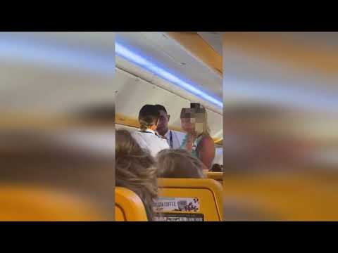 'Riotair' - Shocking video shows 'paralytic' woman being escorted off plane