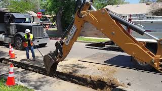 LADWP CASE 590 Super N Backhoe Loader digging trench in Northridge, next to a power conduit