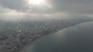 D-Log M. Alanya, Turkey. Aerial view of Oba Beach and Tosmur Beach with city, cloud-covered mount...