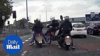 Plain-clothes officers grab three moped thugs on a busy road