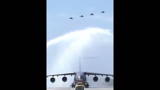 Y-20B moving through the water arch and J-20 formation flying past the stand, welcoming heros home