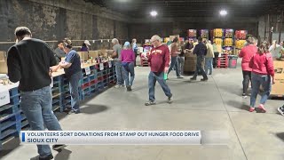 Volunteers sort donations from stamp out hunger food drive