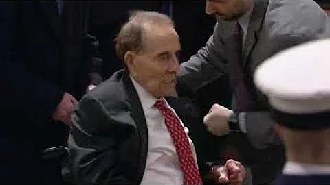 Bob Dole stands to salute former President Bush