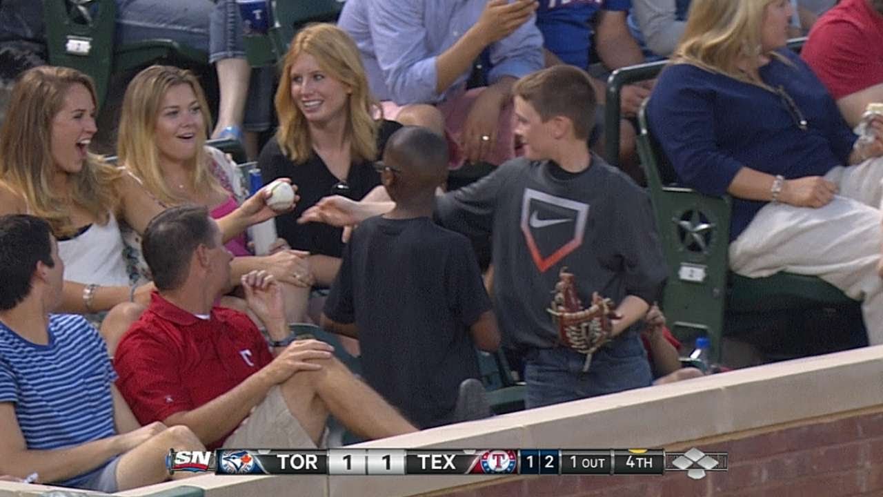 Young fan gives decoy ball to pretty lady 