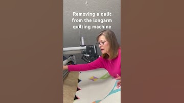 Removing a quilt from the longarm quilting machine. #quilting #longarmquilting #quilt #quiltingtips