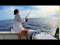 The real florida fishing couple smokes the fish loading the boat with bait and tuna