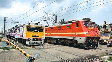 Furious Express & EMU local trains passing through rail gate | busy level crossing
