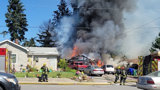 Garage fire reported in Spokane Valley, fire spreading to nearby field