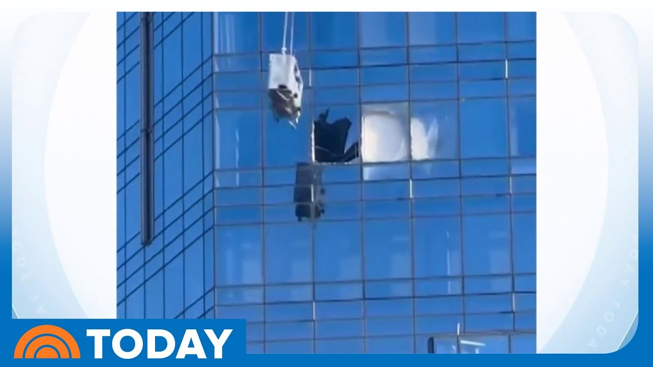 Window washers rescued after being stuck on swinging platform