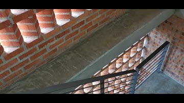 Perforated brick wall that allows natural ventilation for staircase