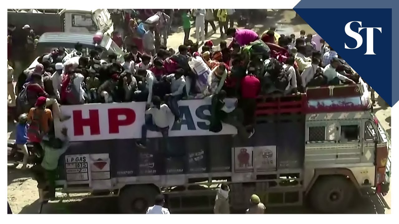 Migrant workers leave cities on trucks in locked down India - YouTube