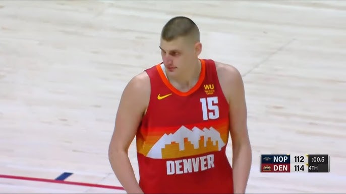 Nikola Jokić wraps dime around defender while falling out of bounds