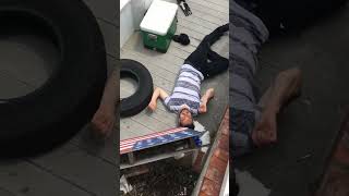 Drunk guy tries to jump railing and lands awkwardly