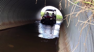 polaris rzr 570 deep water crawling through culvert with mud