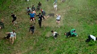 Thrill-seekers roll down a hill in British cheese chase | REUTERS