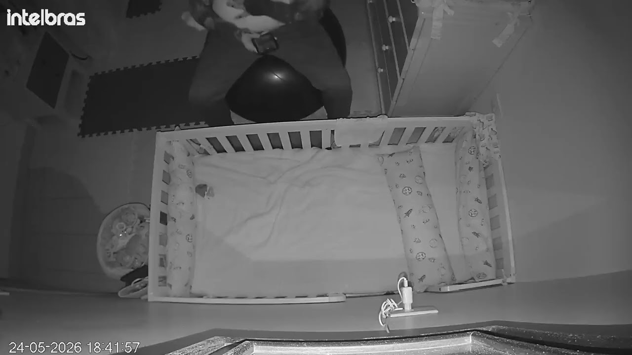 Guy rocking baby near crib bounces on exercise ball that pops (Security camera)