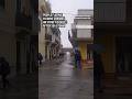 People fleeing as wave crashes on street in Sicily after sea storm