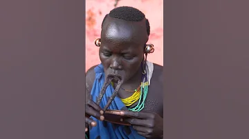Woman from Surma tribe inserts lip plate | Omo Valley Ethiopia #shorts