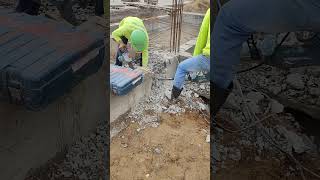Technical breaking concrete beam by workers