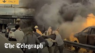 Watch: Moment driver is pulled to safety before flames engulf his car