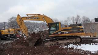 Cat 345BL Excavator digging dirt up close