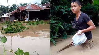 Rescuers Travel In Boat Through Flooded Town