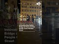 Innovative man builds bridge of chairs to help people cross flooded street