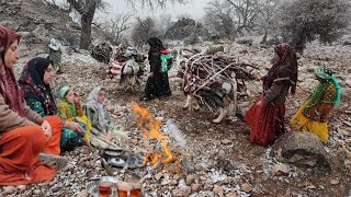 Collecting firewood in the mountain by a village family on a snowy day