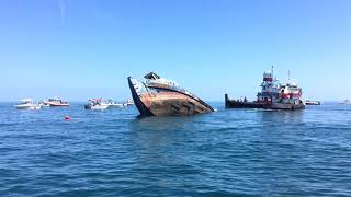 Ship and Tugboat sinking in ocean off of Daytona Beach
