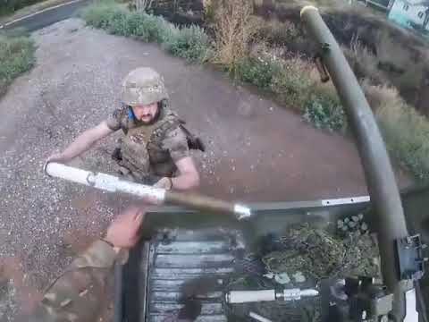 Ukraine soldiers fire an SPG-9 recoilless rifle mounted in the bed of a pickup truck