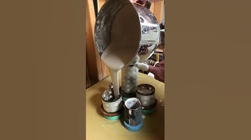 Pouring investment into flasks in preparation for metal casting