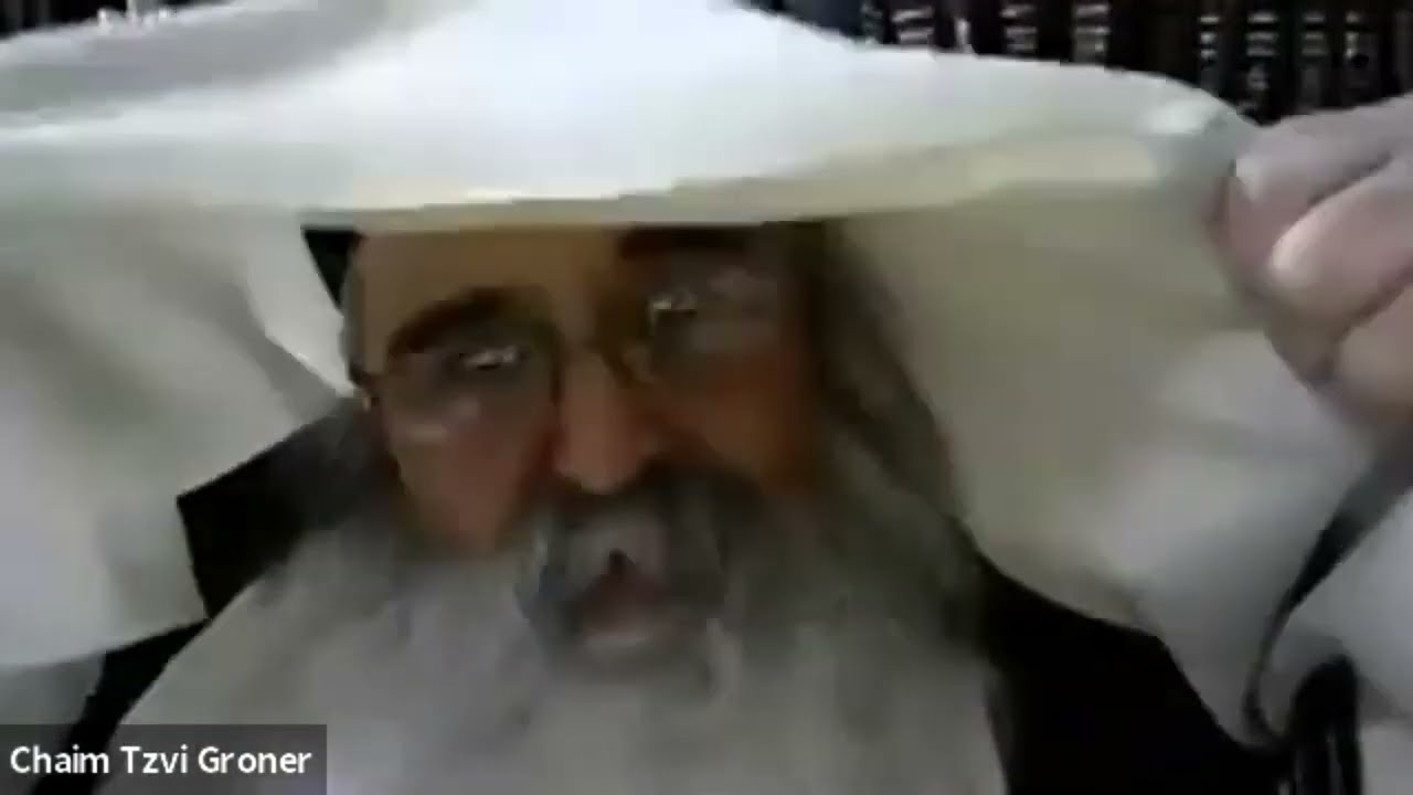 R' Chaim Tzvi Groner demonstrates how the Rebbe wears his Talis during Tekios