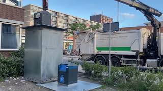 Full Garbage truck emptying an underground container Update